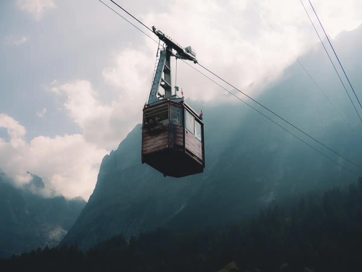 A gondola brings a couple up into the alps