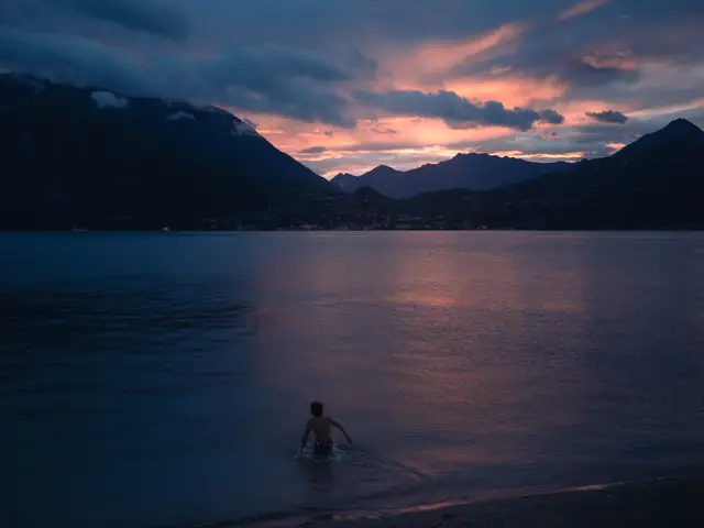 A teenager goes for a swim in the sunset